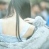 a woman in gray fur coat