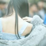 a woman in gray fur coat