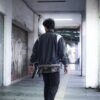 man walking along a corridor