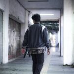 man walking along a corridor