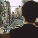 businessman overlooking tokyo cityscape